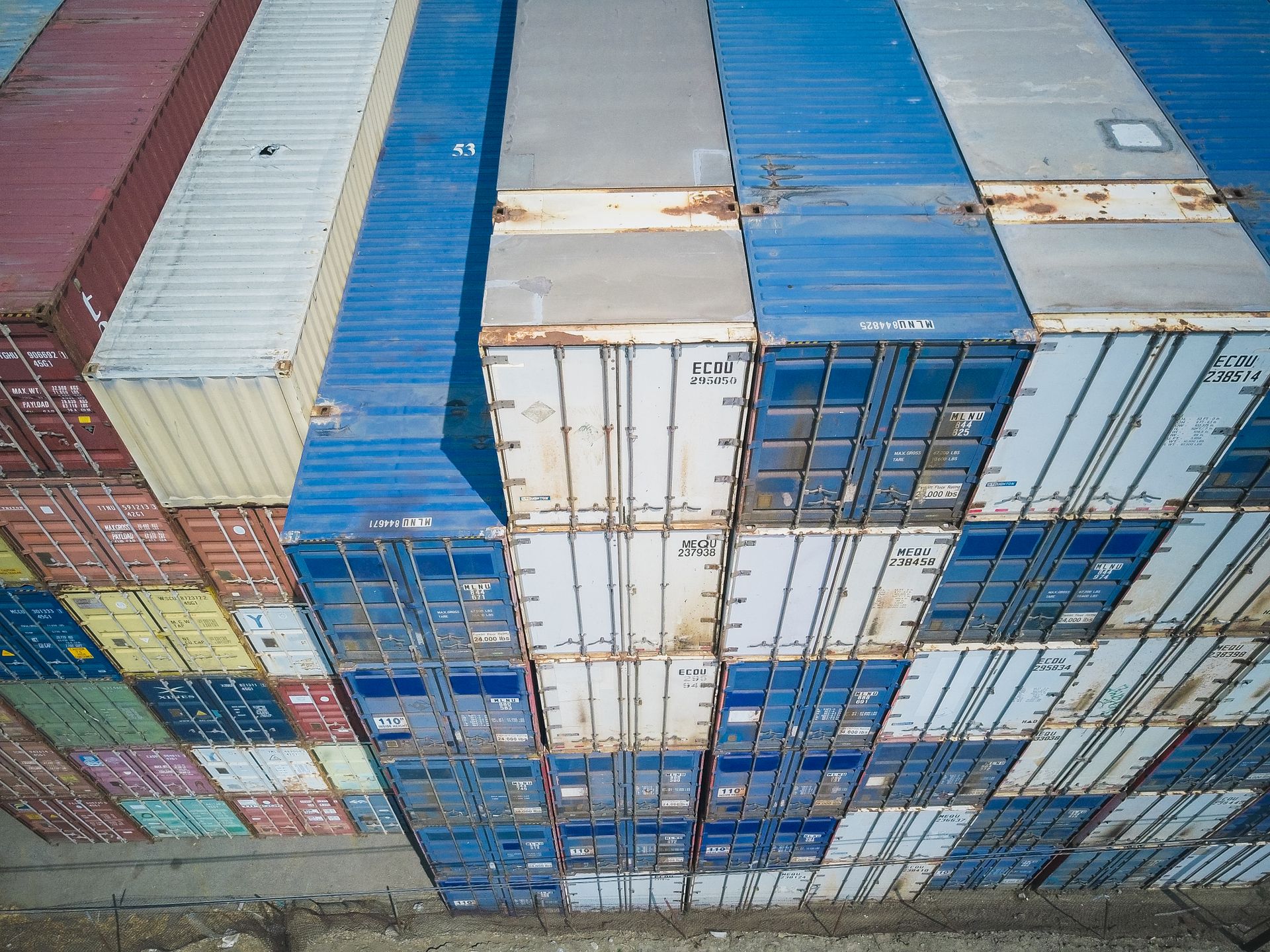 Stacked shipping containers at port, ready for import